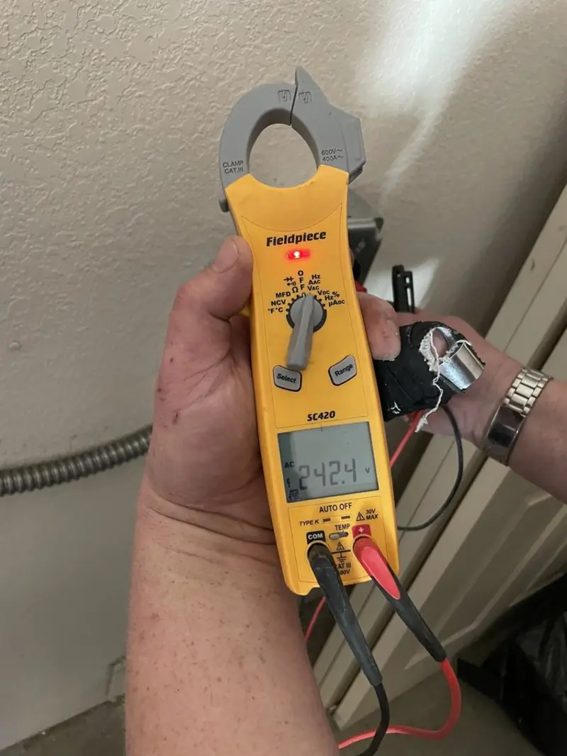 Voltage testing with clamp meter during Outlet Installation in Belterra